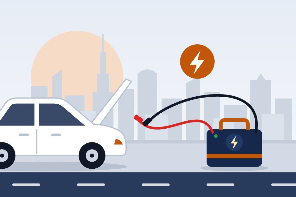 Jump-start cables running from a portable booster pack to a car with its bonnet open
